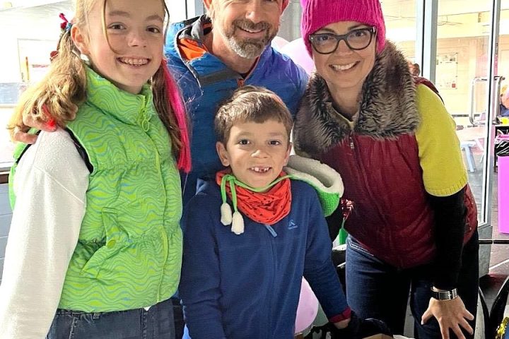 a little girl standing in front of a cake