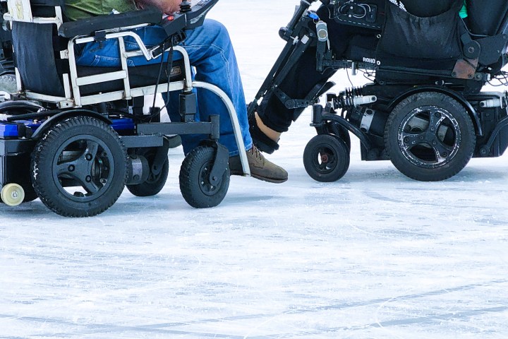 two people in wheelchairs on the ice